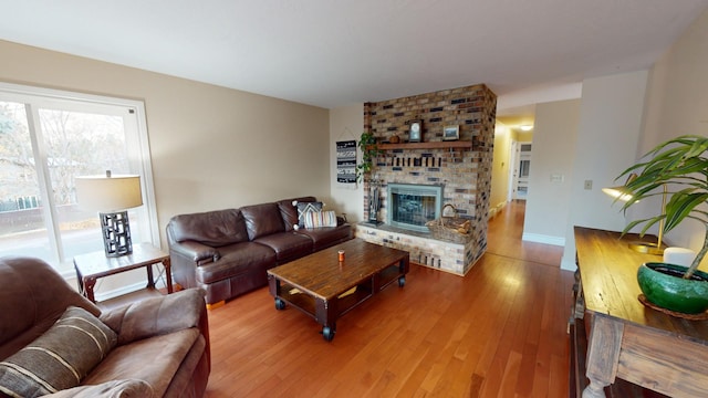 living room with hardwood / wood-style flooring and a fireplace