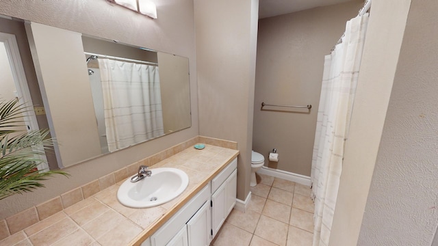 bathroom featuring toilet, vanity, and tile patterned floors