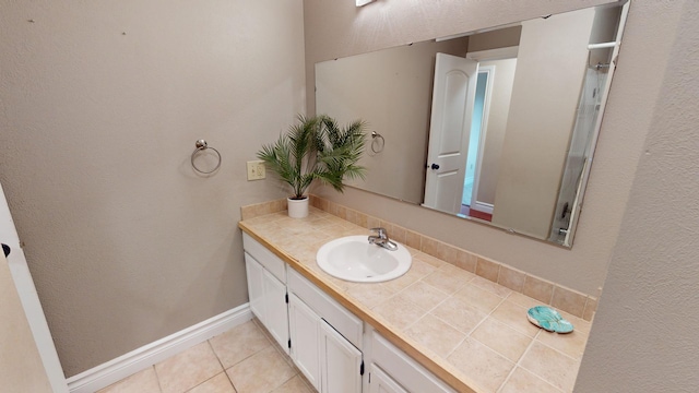 bathroom with tile patterned floors and vanity