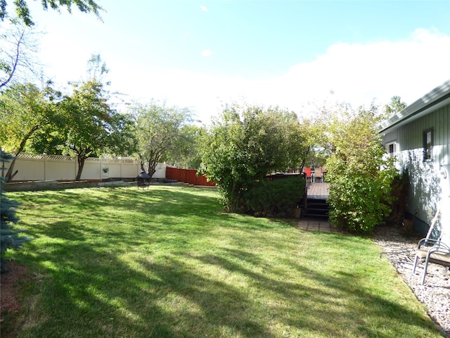 view of yard featuring a wooden deck