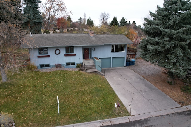 raised ranch with a front yard and a garage