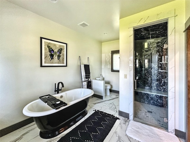 401 Mill St, Sheridan, MT 59749 - bathroom featuring marble finish flooring, a marble finish shower, and a freestanding tub