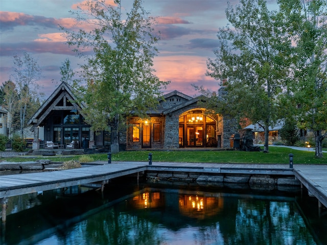 back house at dusk with a yard