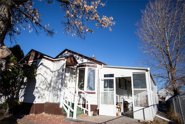 view of front of house featuring a sunroom