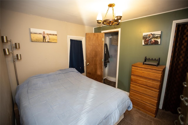 bedroom featuring carpet, a closet, and an inviting chandelier