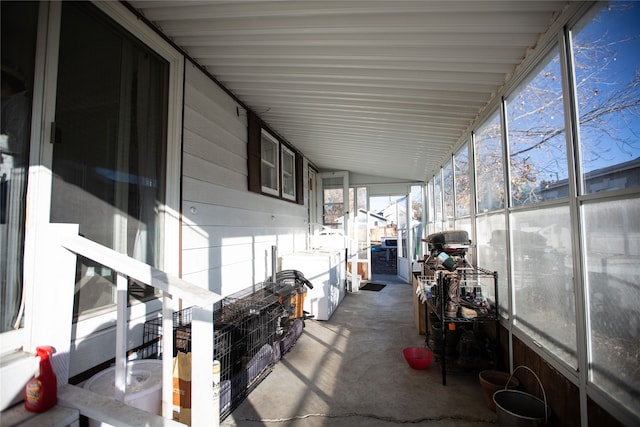 unfurnished sunroom with vaulted ceiling