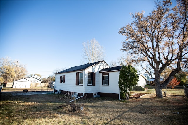 view of side of property with a lawn