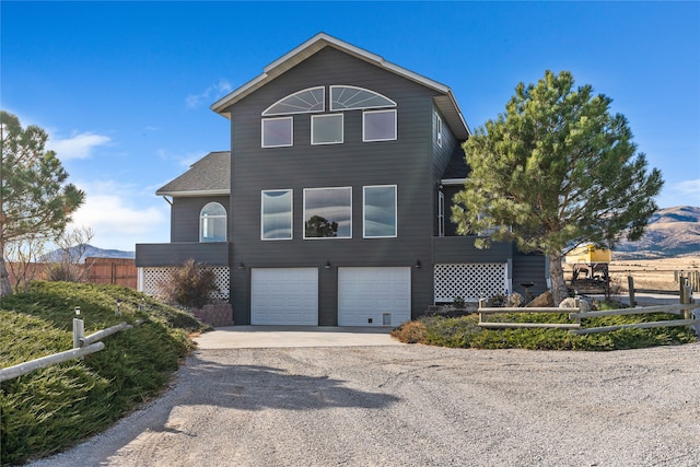 front of property with a mountain view and a garage