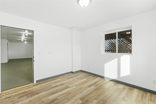 unfurnished room with light hardwood / wood-style floors