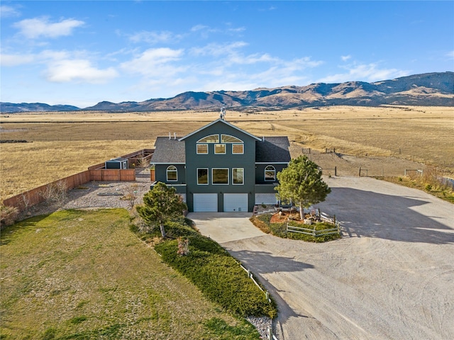 view of front facade featuring a mountain view and a garage