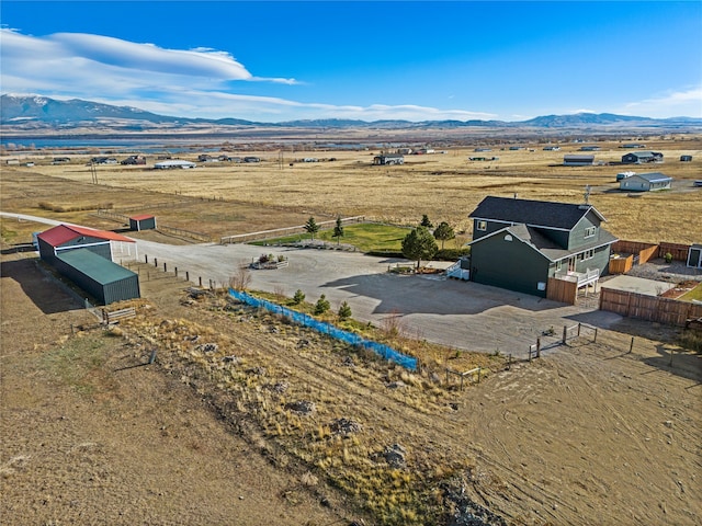 birds eye view of property with a mountain view and a rural view