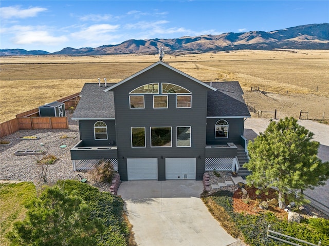 front of property with a mountain view and a garage