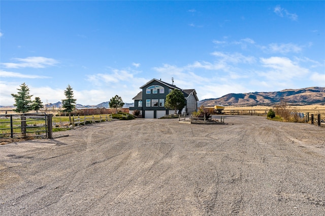 view of front of home featuring a mountain view and a rural view