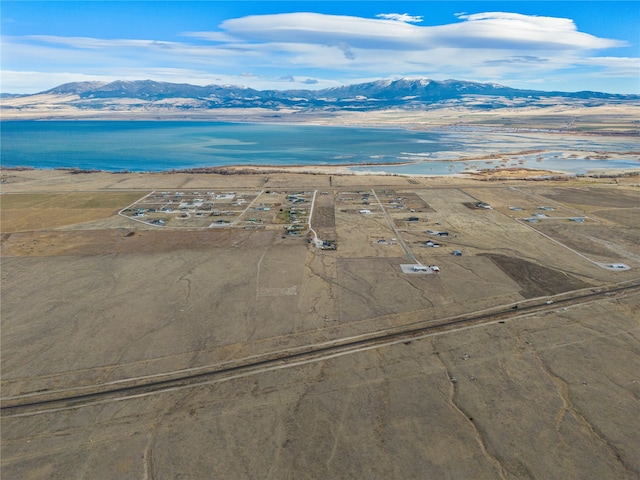 birds eye view of property with a water and mountain view