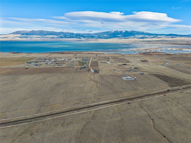 aerial view featuring a water and mountain view