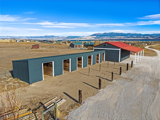 view of front of property with a mountain view and an outbuilding