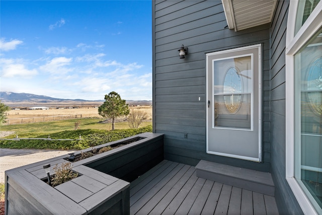 deck featuring a mountain view and a rural view