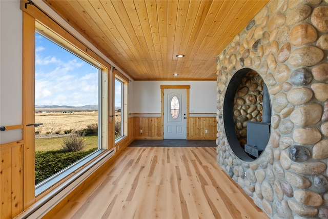 entryway featuring light hardwood / wood-style flooring, plenty of natural light, ornamental molding, and wood ceiling