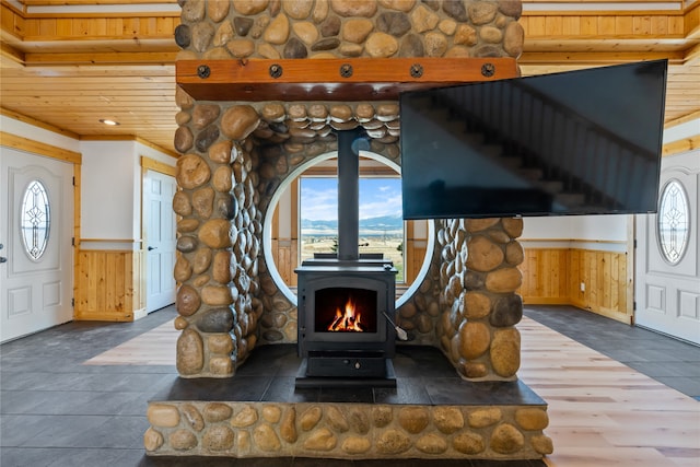 details featuring a wood stove and rustic walls