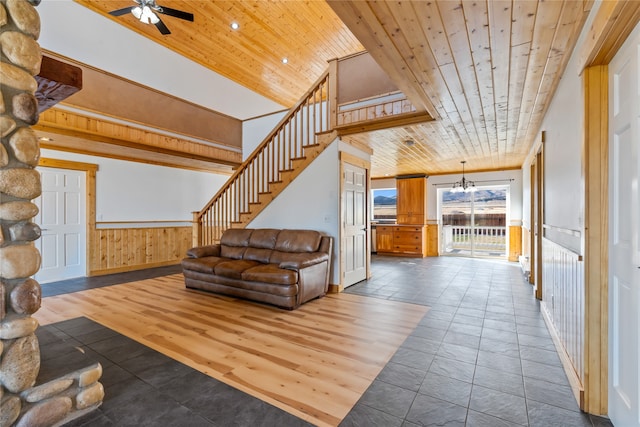 unfurnished living room featuring hardwood / wood-style flooring, vaulted ceiling, ceiling fan, and wooden ceiling