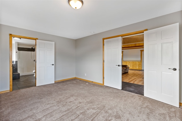 unfurnished bedroom featuring a closet and dark colored carpet