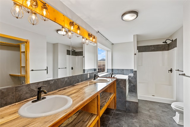 full bathroom featuring plus walk in shower, tile patterned floors, toilet, vanity, and tile walls