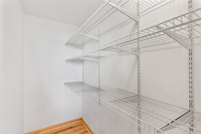 spacious closet featuring hardwood / wood-style floors