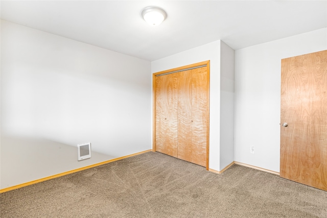 unfurnished bedroom with carpet and a closet