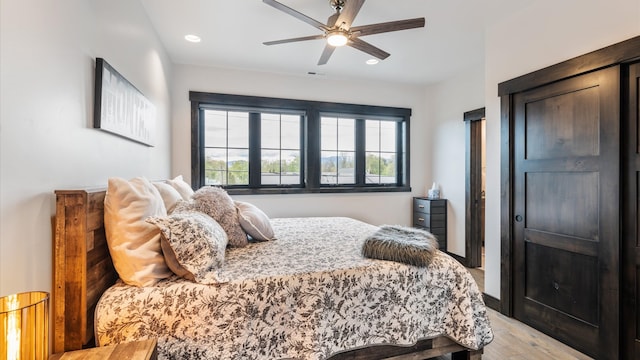 bedroom with light hardwood / wood-style floors and ceiling fan