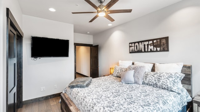 bedroom featuring ceiling fan and dark hardwood / wood-style flooring