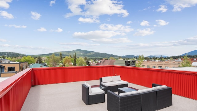 view of patio with a mountain view and a balcony