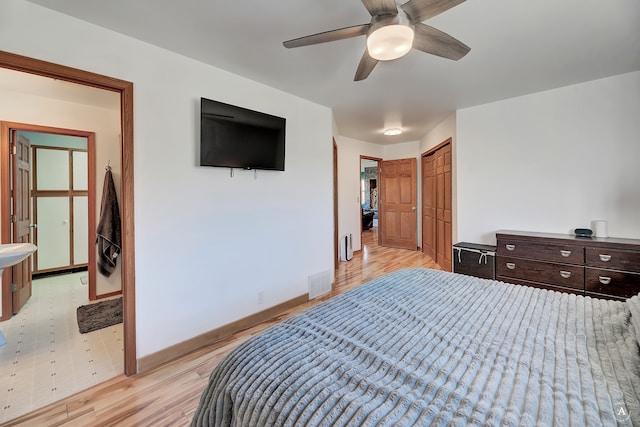 bedroom with ceiling fan, a closet, and light hardwood / wood-style flooring