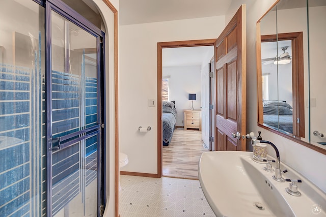 bathroom with hardwood / wood-style floors, sink, ceiling fan, toilet, and a wealth of natural light