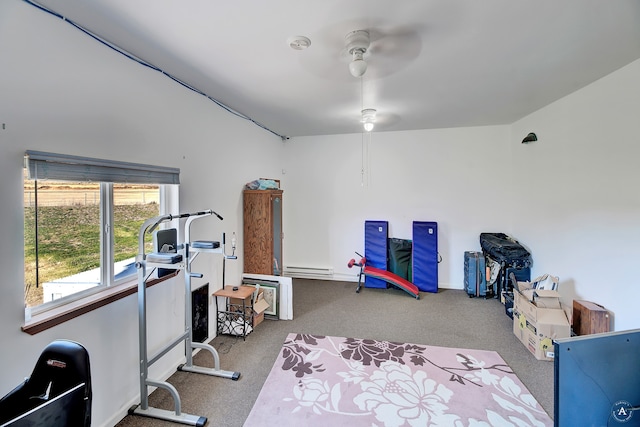 exercise room with baseboard heating, light carpet, and ceiling fan