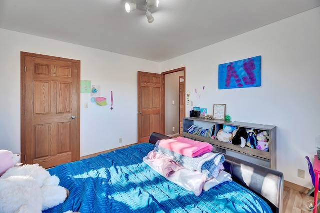 bedroom featuring wood-type flooring