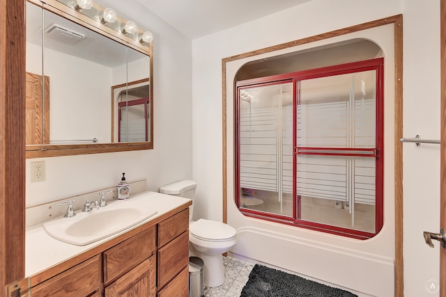 full bathroom featuring tile patterned flooring, vanity, toilet, and shower / bath combination with glass door