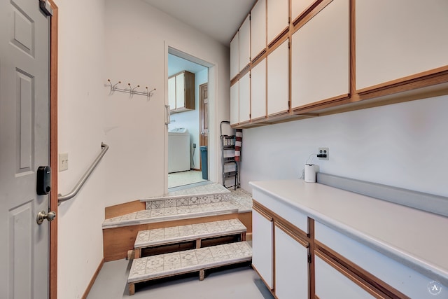 stairs featuring washer / clothes dryer