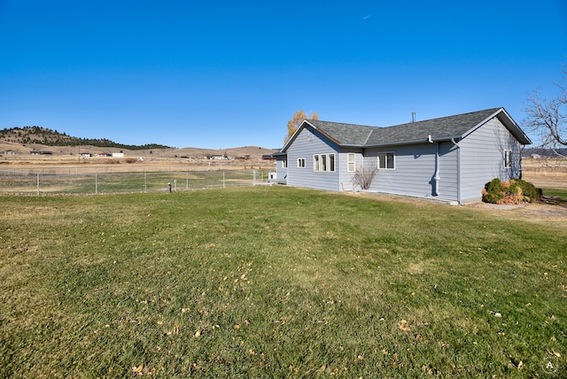 exterior space with a mountain view, a rural view, and a lawn