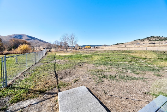 view of yard with a mountain view and a rural view