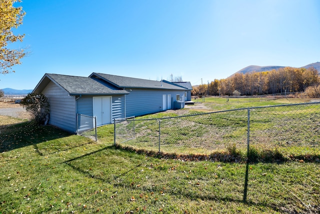 exterior space with a lawn and a mountain view