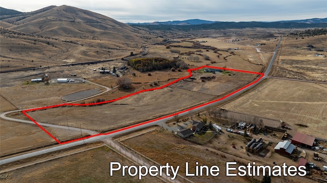 birds eye view of property with a mountain view