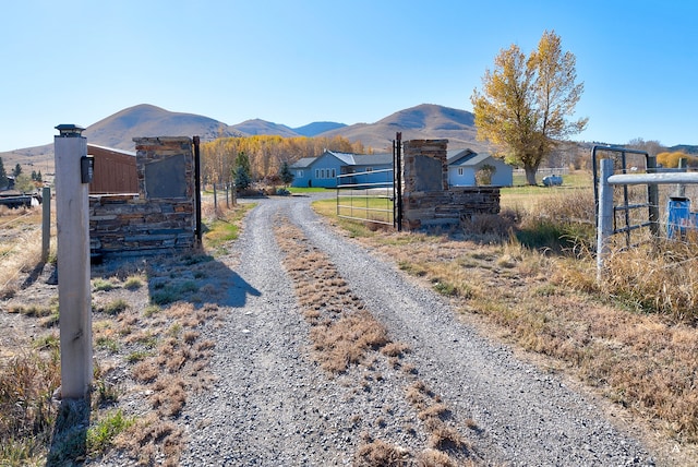 view of street with a mountain view and a rural view