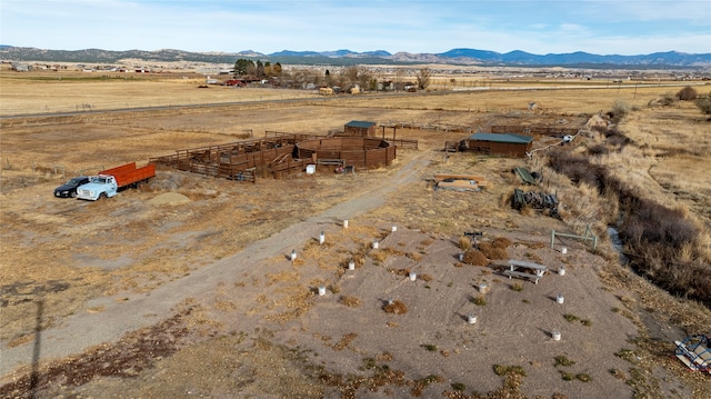 birds eye view of property featuring a mountain view and a rural view