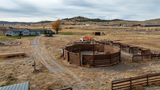 view of yard with a mountain view and a rural view