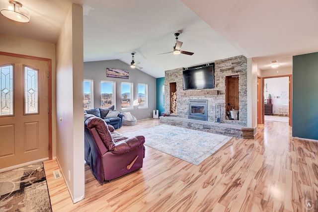 living room featuring light hardwood / wood-style floors, a wealth of natural light, lofted ceiling, and ceiling fan