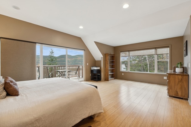 bedroom with access to outside, light hardwood / wood-style flooring, and multiple windows