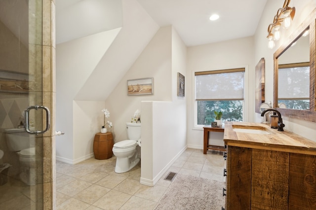 bathroom featuring tile patterned floors, vanity, an enclosed shower, and toilet