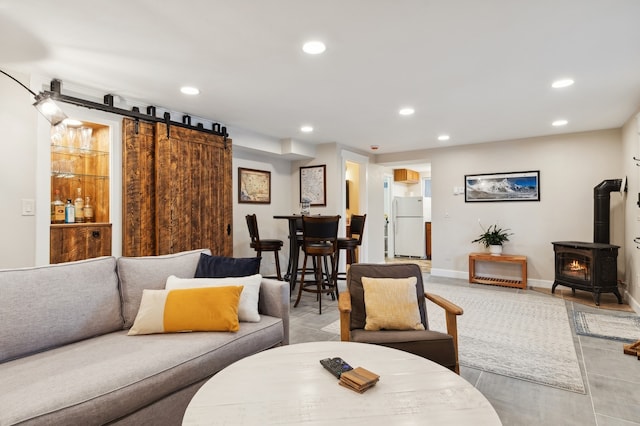 living room with light tile patterned floors and a wood stove