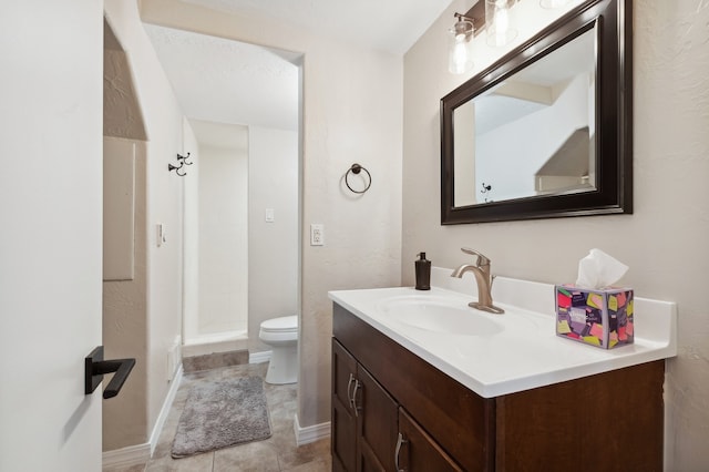 bathroom with a textured ceiling, vanity, a shower, tile patterned flooring, and toilet