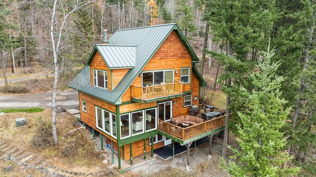 rear view of property with a balcony